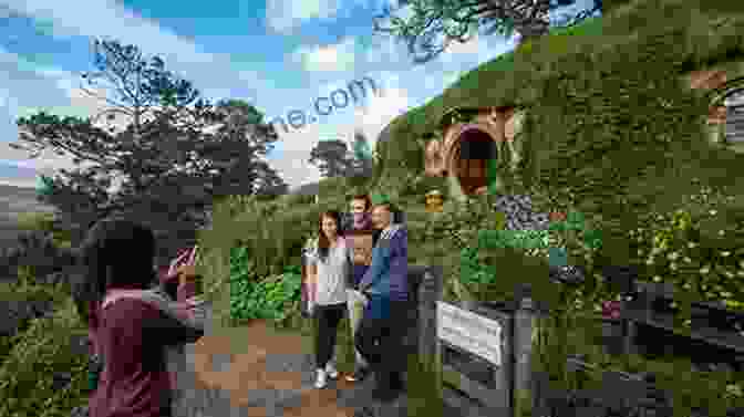 A Group Of Tourists Walking Through The Hobbiton Movie Set In New Zealand New Zealand Photo Journal #4: Visiting Hobbiton Shire